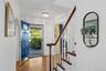 Entry foyer is warmed by hardwood floors & natural light from 2nd floor landing
