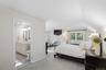 Primary bedroom is spacious and serene offering two WIC and access to the renovated bath