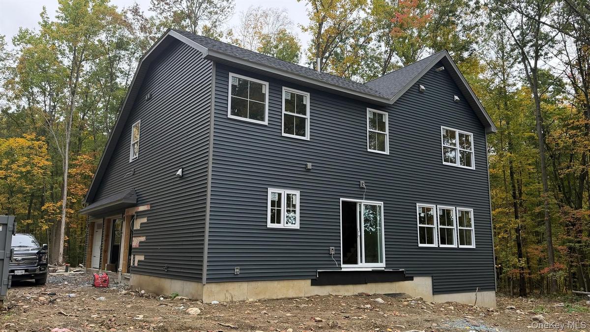 Construction Progress Photo of Exterior Siding Installation in Progress.