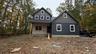 Construction Progress Photo of Exterior Siding Installation in Progress.
