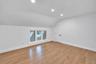 2nd floor Bedroom featuring wood-finish flooring, sloped ceilings, recessed lighting, and a multi-pane window with white trim
