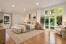 Vaulted ceilings, wood-finish flooring, recessed lighting, and expansive multi-pane windows