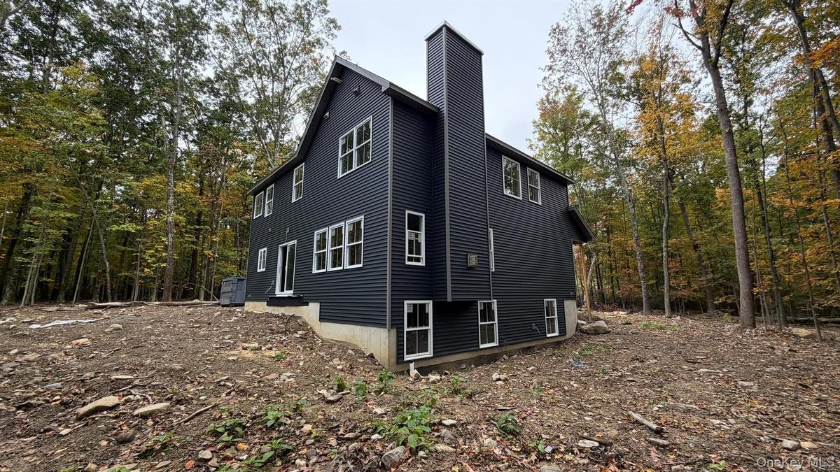 Construction Progress Photo of Exterior Siding Installation in Progress.