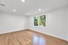 2nd floor bedroom featuring wood-finish flooring, recessed lighting, and a multi-pane window