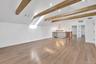2nd floor loft. Vaulted ceiling featuring exposed wood beams, wood-finish flooring, recessed lighting, and a metal spindle railing