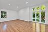 Interior space featuring polished wood-finish flooring, recessed lighting, and a vaulted ceiling