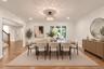 Dining area featuring wood-finish flooring, recessed lighting, crown molding, and a tiered crystal drum chandelier