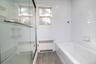 main floor bathroom featuring a tub and shower
