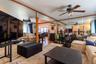 Interior space featuring full-wall mirrors, wood-trim accents, and a ceiling fan with integrated lighting