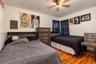 Interior room featuring wood-finish flooring, a ceiling fan with light fixture, and neutral wall coloring