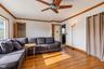 Wood-finish flooring, crown molding, and ceiling fan with integrated light fixture