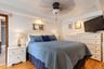 Bedroom featuring hardwood flooring, recessed ceiling lighting, a central ceiling fan, and crown molding