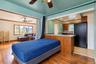 Wood-finish flooring, kitchen featuring a wooden peninsula with a tile countertop, recessed lighting, and a ceiling fan