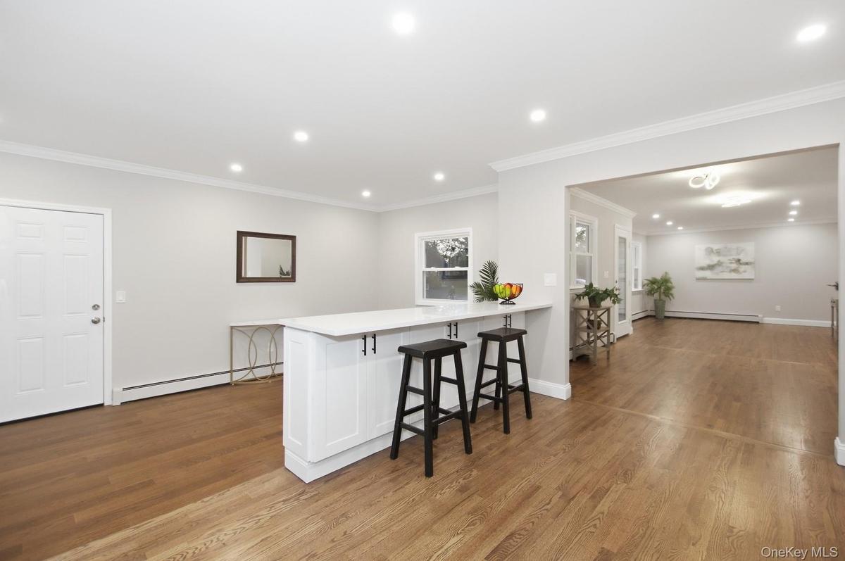 Kitchen - Island overlooking den and view into dining & living rooms