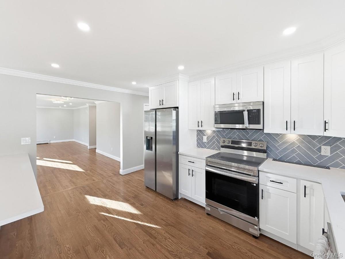 Kitchen view into dining & living rooms seamlessly connects these rooms for a fluid entertaining space.