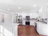 Spacious Kitchen is the center of this home with its oversized peninsula,  new appliances, quartz countertops and stylish backsplash.