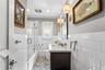 Bathroom featuring white subway tile wall cladding, a Marable countertop vanity with an undermount sink, a shower enclosure with a glass door, and pat
