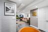 Interior space featuring textured grey wall coverings, recessed ceiling lighting, and large-format tile flooring