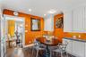 Kitchen featuring white custom cabinetry, neutral-toned solid surface countertops, recessed lighting, and large-format tile flooring