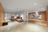 Warm wood paneling, polished concrete flooring, recessed lighting, and a modern lounge seating area