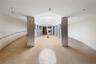 Sophisticated commercial or gallery space featuring soaring ceilings with recessed lighting, polished concrete flooring, and distinctive textured ston