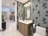 Powder room featuring a single vanity with a white countertop and wood-finish cabinetry
