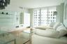 Living area featuring floor-to-ceiling glass sliding doors, built-in white cabinetry with glass shelving, wood-finish flooring, and recessed ceiling l