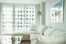 Living room with white sectional sofa and floor-to-ceiling windows