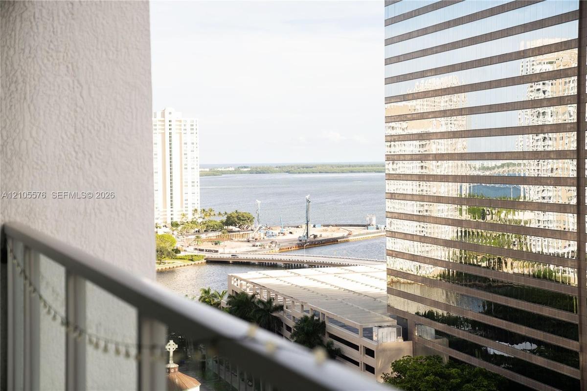 Private balcony featuring a metal railing with glass panels