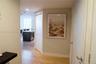 Neutral-toned interior featuring wood-finish flooring, recessed lighting, and white interior doors with contemporary metallic hardware