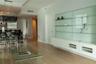 Wood-finish flooring, custom built-in white cabinetry with glass shelving, and a linear pendant light fixture
