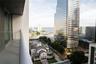 Private balcony with a metal railing, overlooking urban architecture and a water corridor