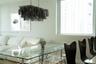 Rectangular tiered chandelier with dark metallic finish and large, expansive window with aluminum framing