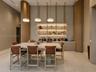 Built-in cabinetry featuring wood-paneled pillars, integrated tiered shelving with recessed lighting, stone-surface central island, and stone-finish f