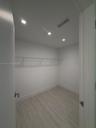 Storage space featuring wood-finish flooring, recessed lighting, and wall-mounted wire shelving
