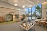 Expansive room featuring floor-to-ceiling windows, custom tray ceiling, integrated spherical pendant lighting, and built-in wall niches