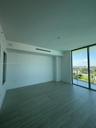 Floor-to-ceiling glass sliding doors, private balcony, wood-finish tile flooring, recessed ceiling HVAC, and neutral wall finishes