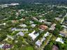 Aerial perspective of a multi-level contemporary estate featuring a rectangular swimming pool, integrated hardscaping, established perimeter landscapi