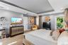 Tray ceiling with recessed lighting, neutral wall color, and glass door access to an exterior balcony