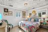 First Floor Bedroom with Distinctive hexagonal patterned ceiling treatment, dual windows with crisp white casing, and a central flush-mount geometric 
