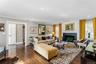 Living space featuring wood-finish flooring, a granite fireplace surround, recessed lighting