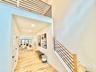 Hall with light wood finished floors and recessed lighting