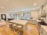 Kitchen with stainless steel appliances, decorative backsplash, recessed lighting, a center island, and light wood-style floors