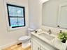 Half bath featuring vanity and light wood-style flooring