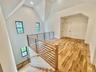Bonus room featuring light wood-type flooring and high vaulted ceiling