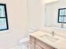 Bathroom with vanity and marble finish flooring