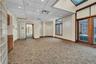 Empty room featuring a drop ceiling and dark carpet
