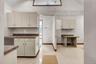 Kitchen featuring vaulted ceiling, dark countertops, and light tile patterned flooring