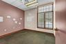 Spare room with a drop ceiling and dark colored carpet