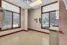 Empty room with a paneled ceiling, healthy amount of natural light, and light flooring